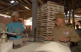 Il Comandante della Rivoluzione Juan Almeida dialoga con un lavoratore della fabbrica di mattonelle.